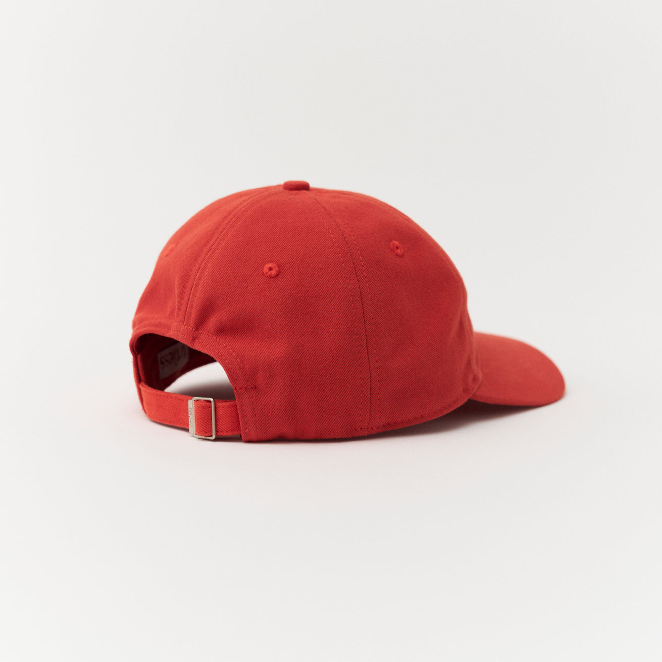Artless red cap with blue text side profile
