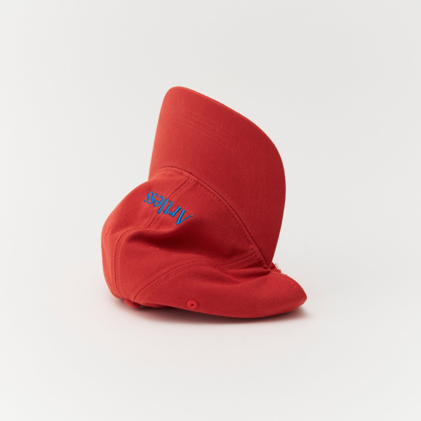 Artless red cap with blue text