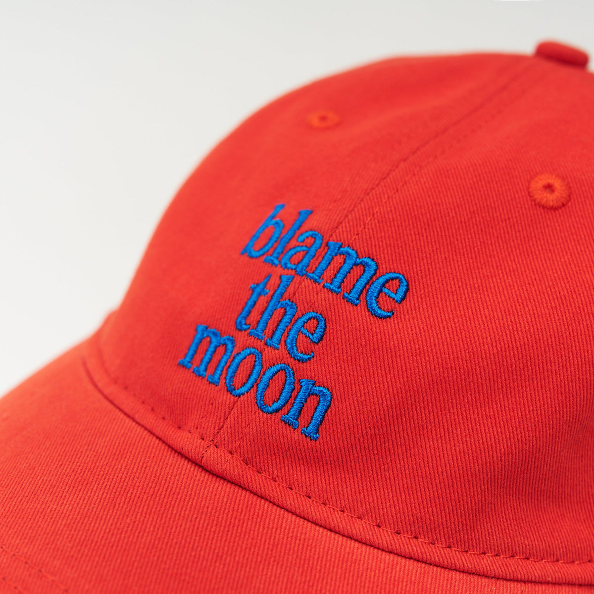 Red Artless blame the moon organic dad cap with blue embroidery, unstructured 6-panel GOTS organic cotton