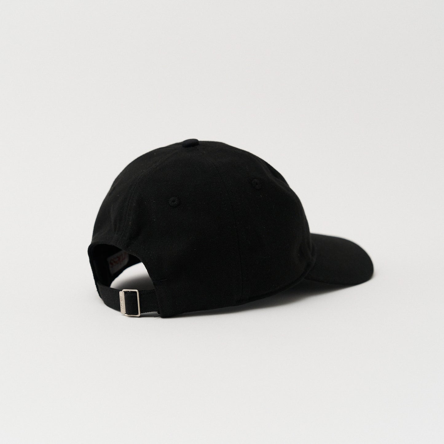 black Close up of the embroidery of a green unstructured 6-panel dad cap made from GOTS certified organic cotton by Artless back view