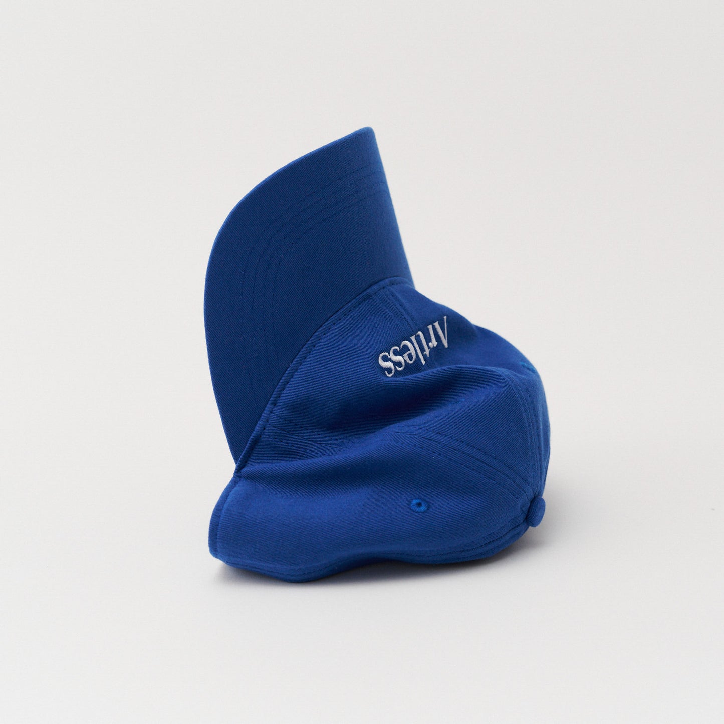 blue unstructured 6-panel dad cap made from GOTS certified organic cotton by Artless tipped on its side