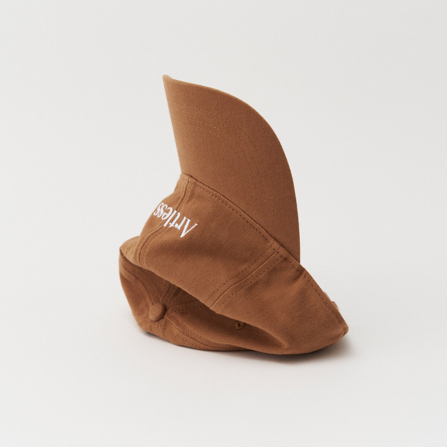 Brown unstructured 6-panel dad cap made from GOTS certified organic cotton by Artless tipped on its side