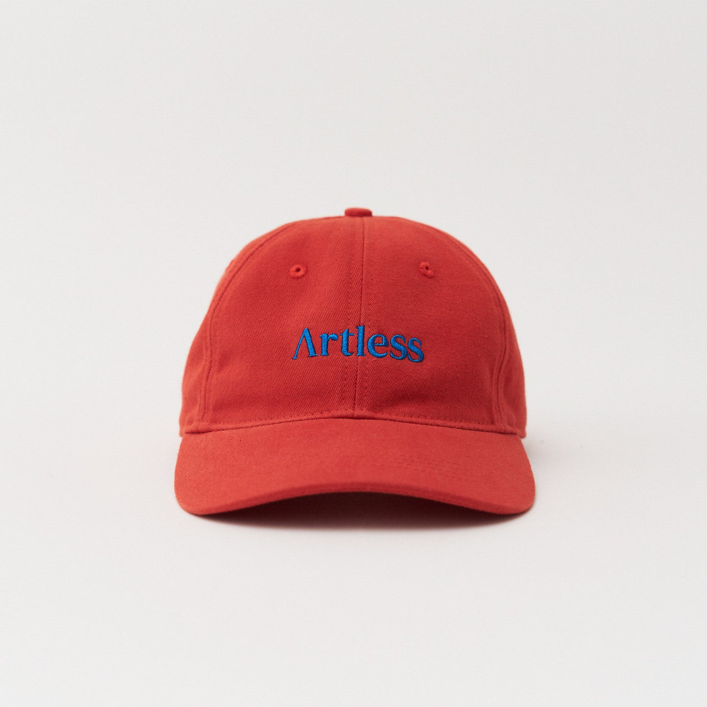Red unstructured 6-panel dad cap made from GOTS certified organic cotton by Artless front view