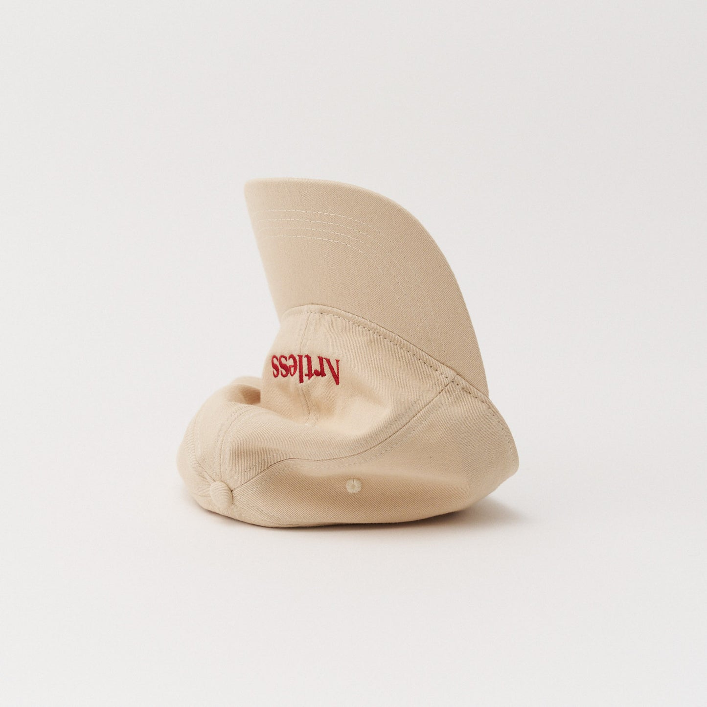 Sand coloured unstructured 6-panel dad cap made from GOTS certified organic cotton by Artless tipped on its side