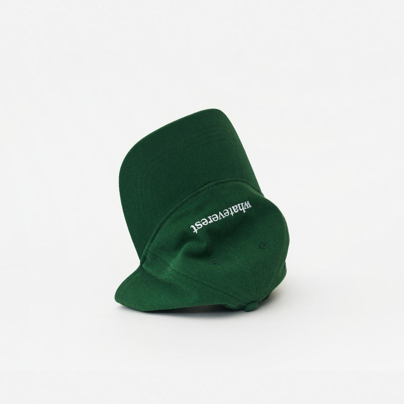 Green Artless Whateverest organic dad cap, laying on its side