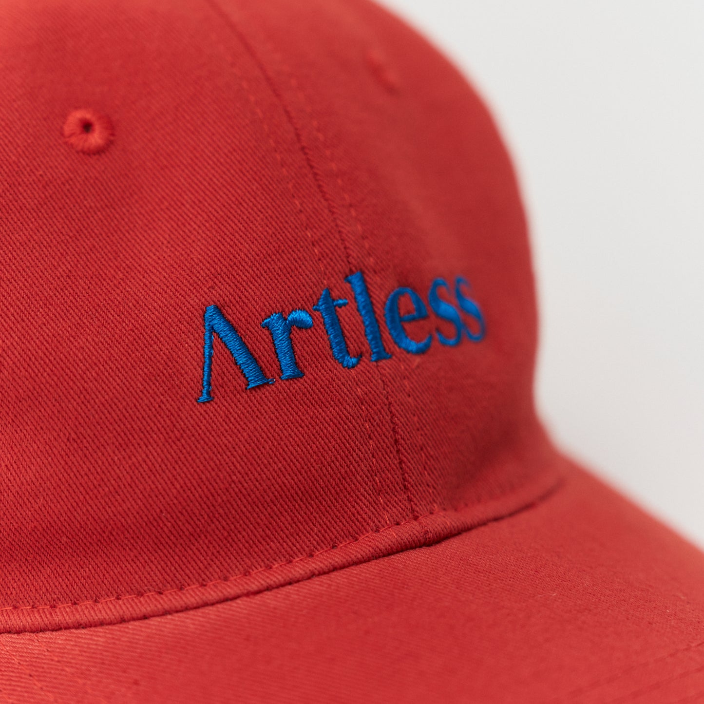 Artless red cap with blue text detail
