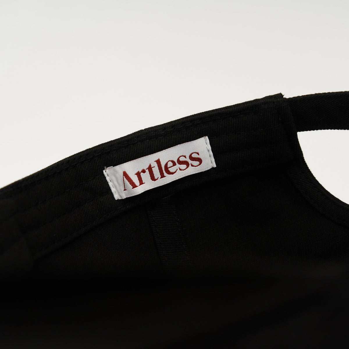 Black Artless blame the moon organic dad cap, close up of embroidery, GOTS organic cotton