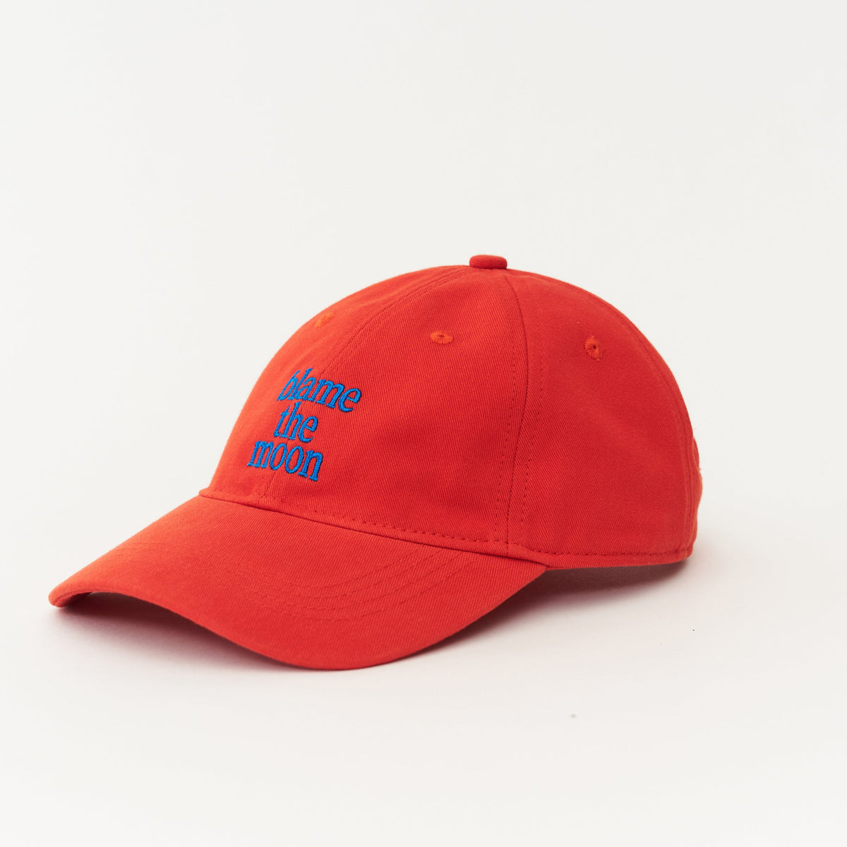 Red Artless blame the moon organic dad cap with blue embroidery, close up of embroidery, GOTS organic cotton