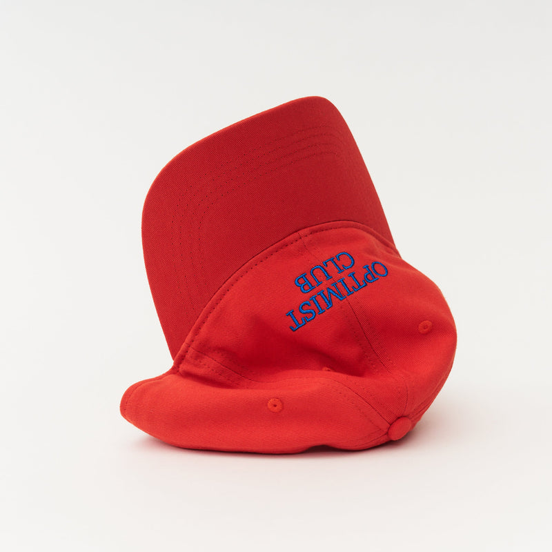 Red Artless Optimist Club organic dad cap with blue embroidery, unstructured 6-panel GOTS organic cotton