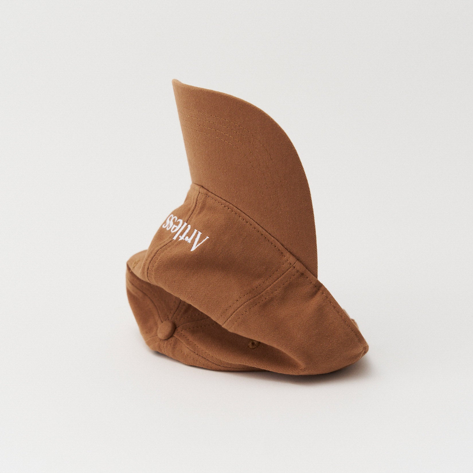 Brown unstructured 6-panel dad cap made from GOTS certified organic cotton by Artless tipped on its side