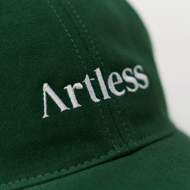 Close up of the embroidery of a green unstructured 6-panel dad cap made from GOTS certified organic cotton by Artless