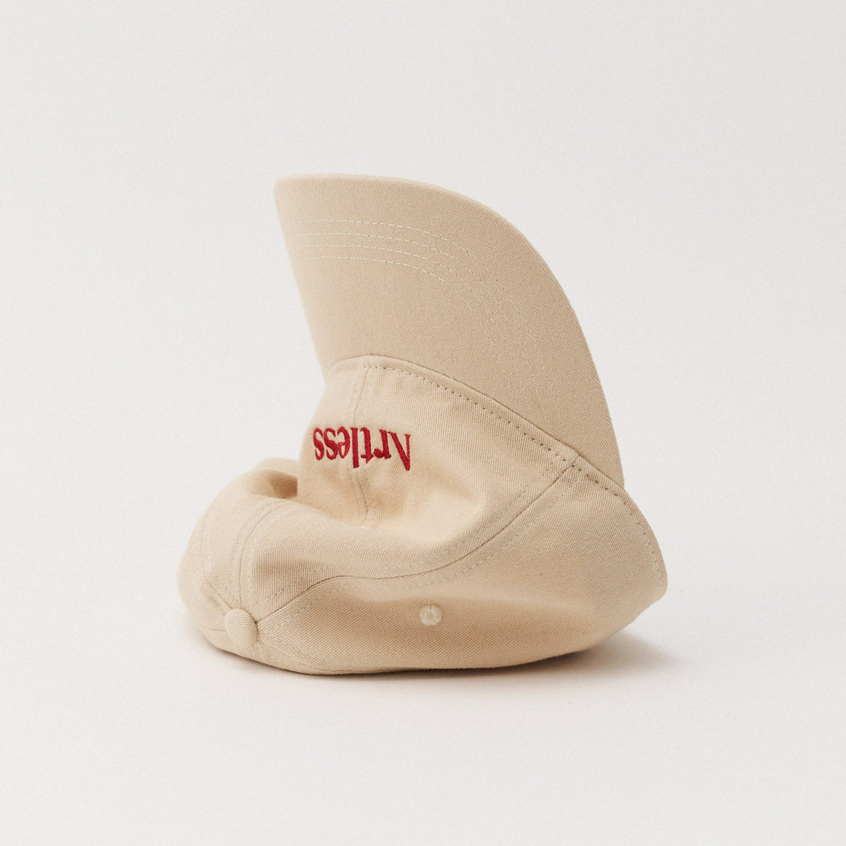 Sand coloured unstructured 6-panel dad cap made from GOTS certified organic cotton by Artless tipped on its side