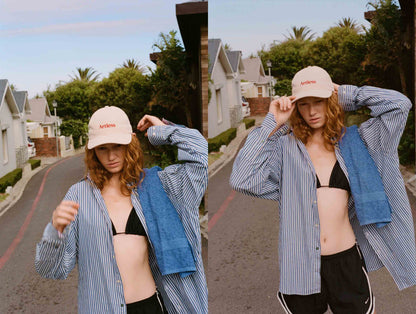 woman wearing a sand coloured unstructured 6-panel dad cap made from GOTS certified organic cotton by Artless