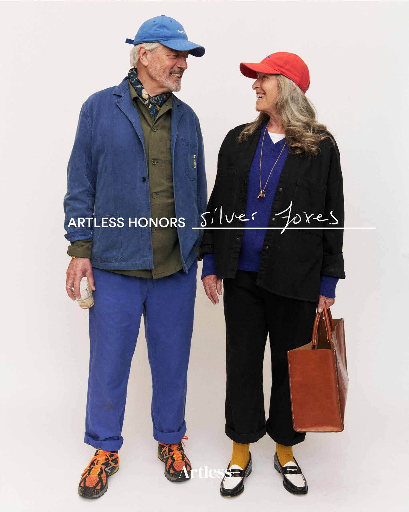 older stylish couple smiling at each other wearing a blue and red unstructured 6-panel dad cap made from GOTS certified organic cotton by Artless