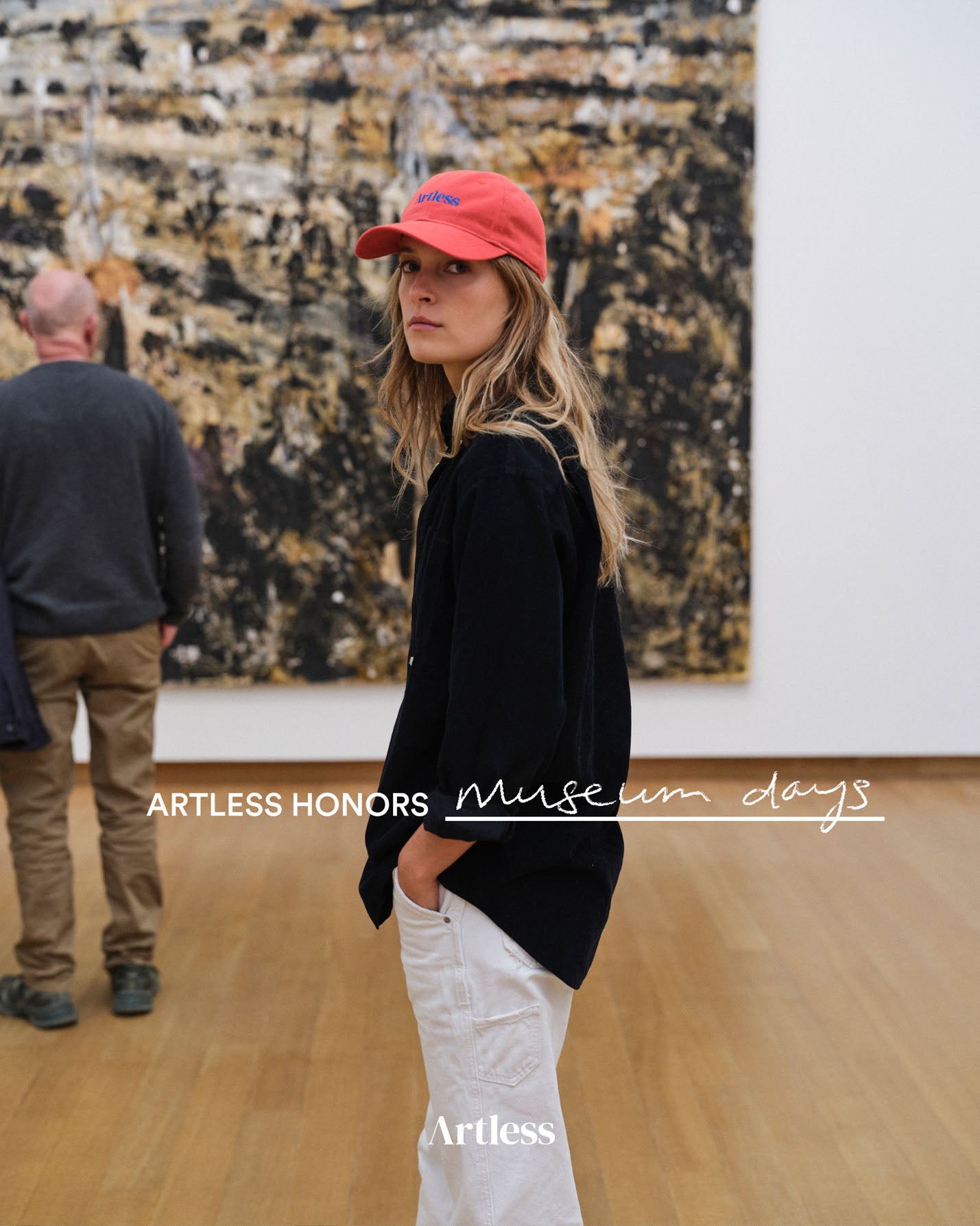 a woman in a museum wearing a red unstructured 6-panel dad cap made from GOTS certified organic cotton by Artless with modern art in the background