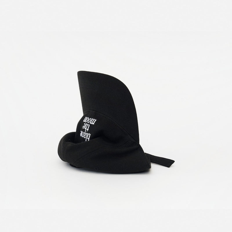 Black Artless Blame the Moon organic dad cap, laying on its side