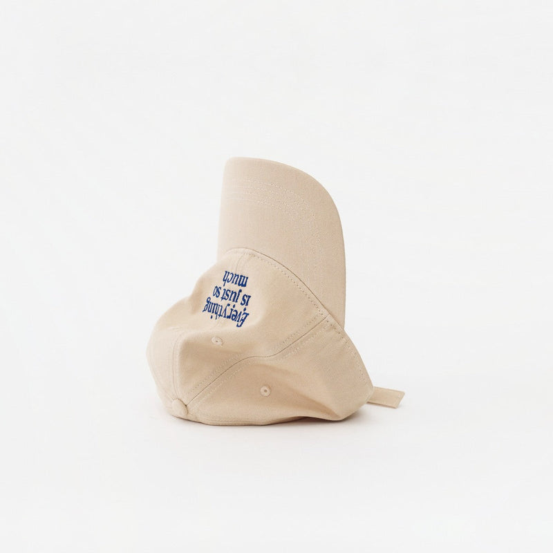 Sand Artless Everything Is Just So Much organic dad cap, laying on its side