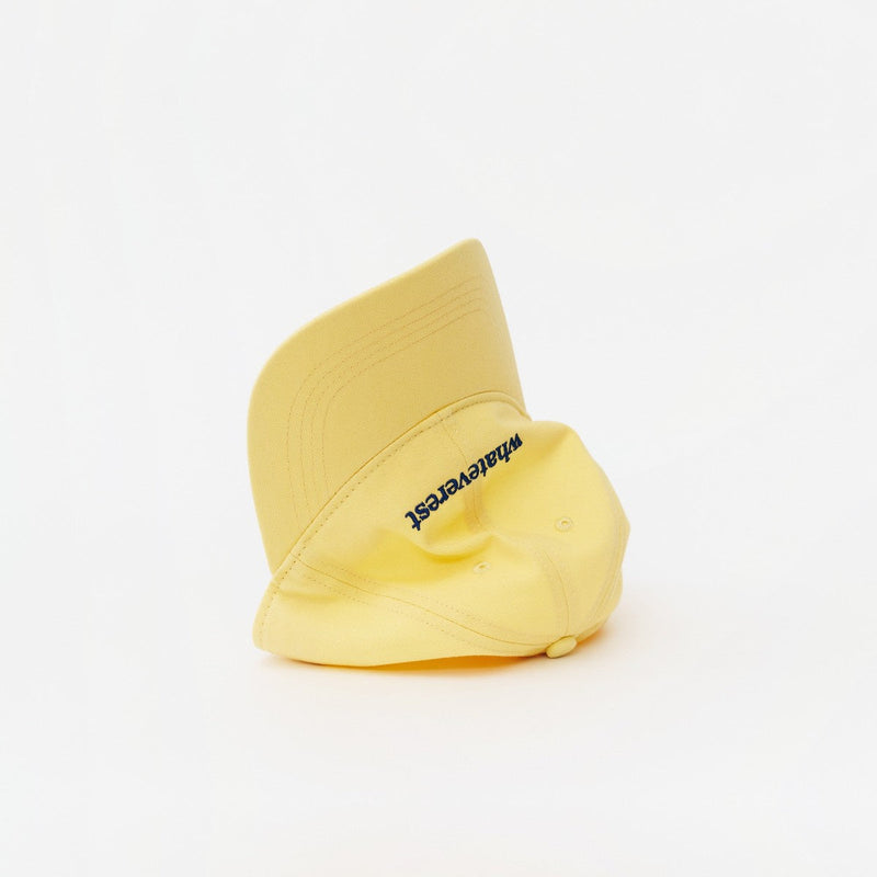 Butter Yellow Artless Whateverest organic dad cap, laying on its side